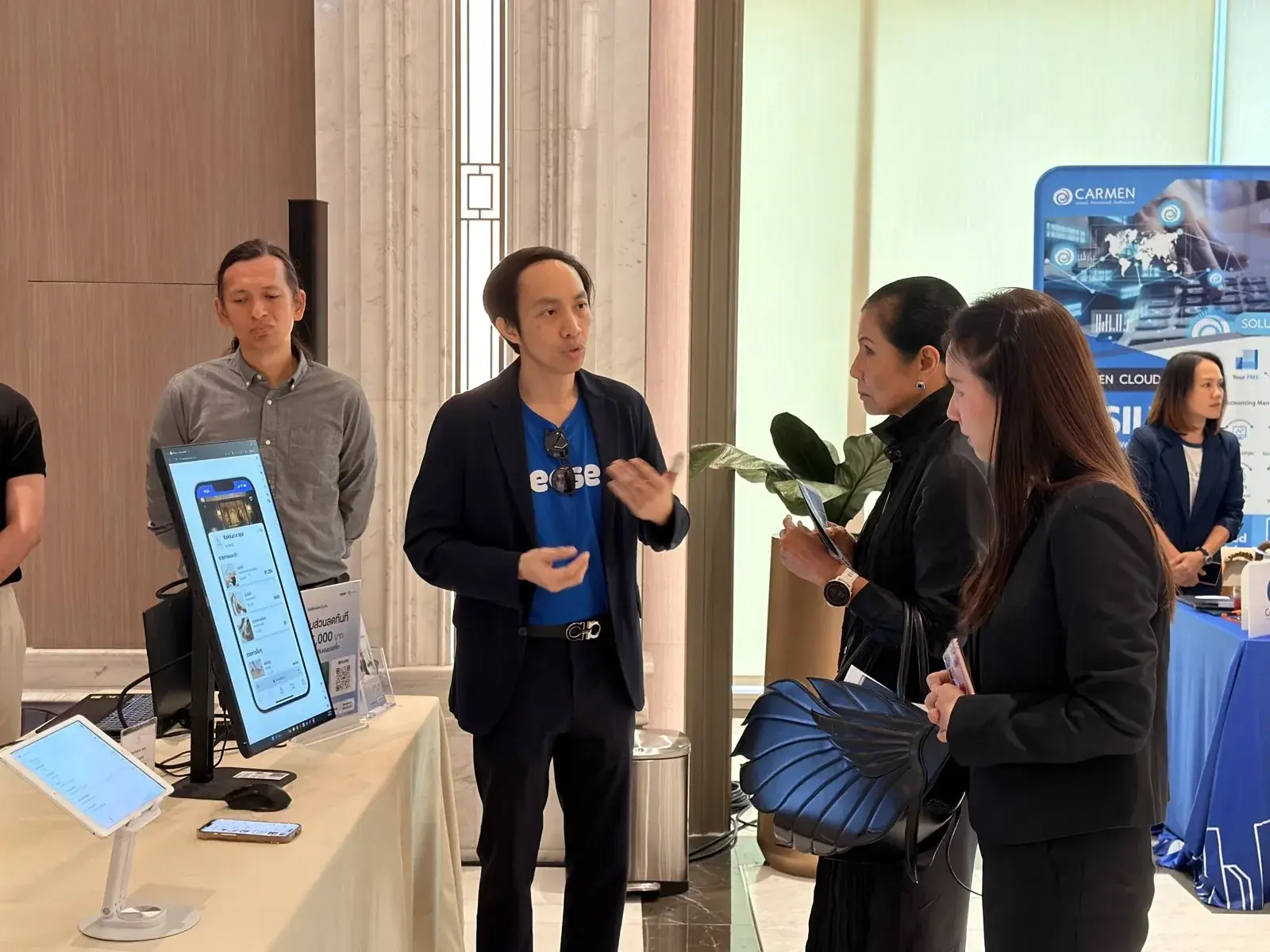 Ease POS team demonstrating the product to business visitors